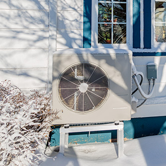 11air source heat pump outside in the snow